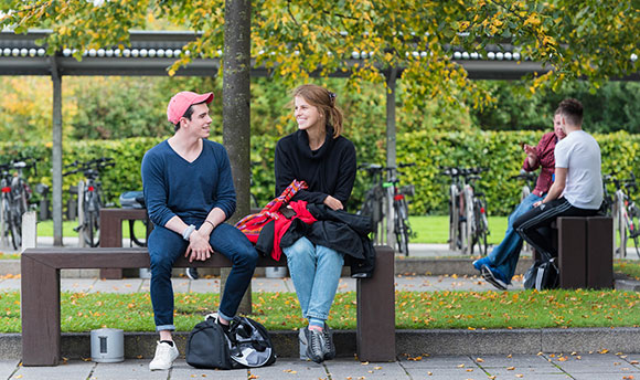 Students talking on the benches outside 69传媒, Edinburgh