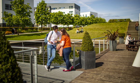 A couple of students chatting in the sun at QMU, Edinburgh
